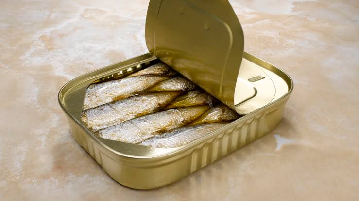 An open tin of sardines